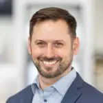 Greg Aguilera wearing a blue jacket and shirt - and of course a smile!